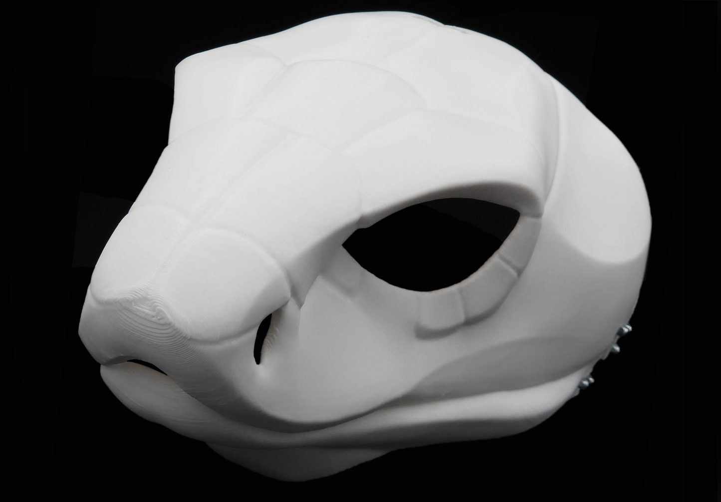 Photo showing a white, plastic 3D printed cobra snake fursuit head base complete with metal hardware at a 3/4 angle against a black background.