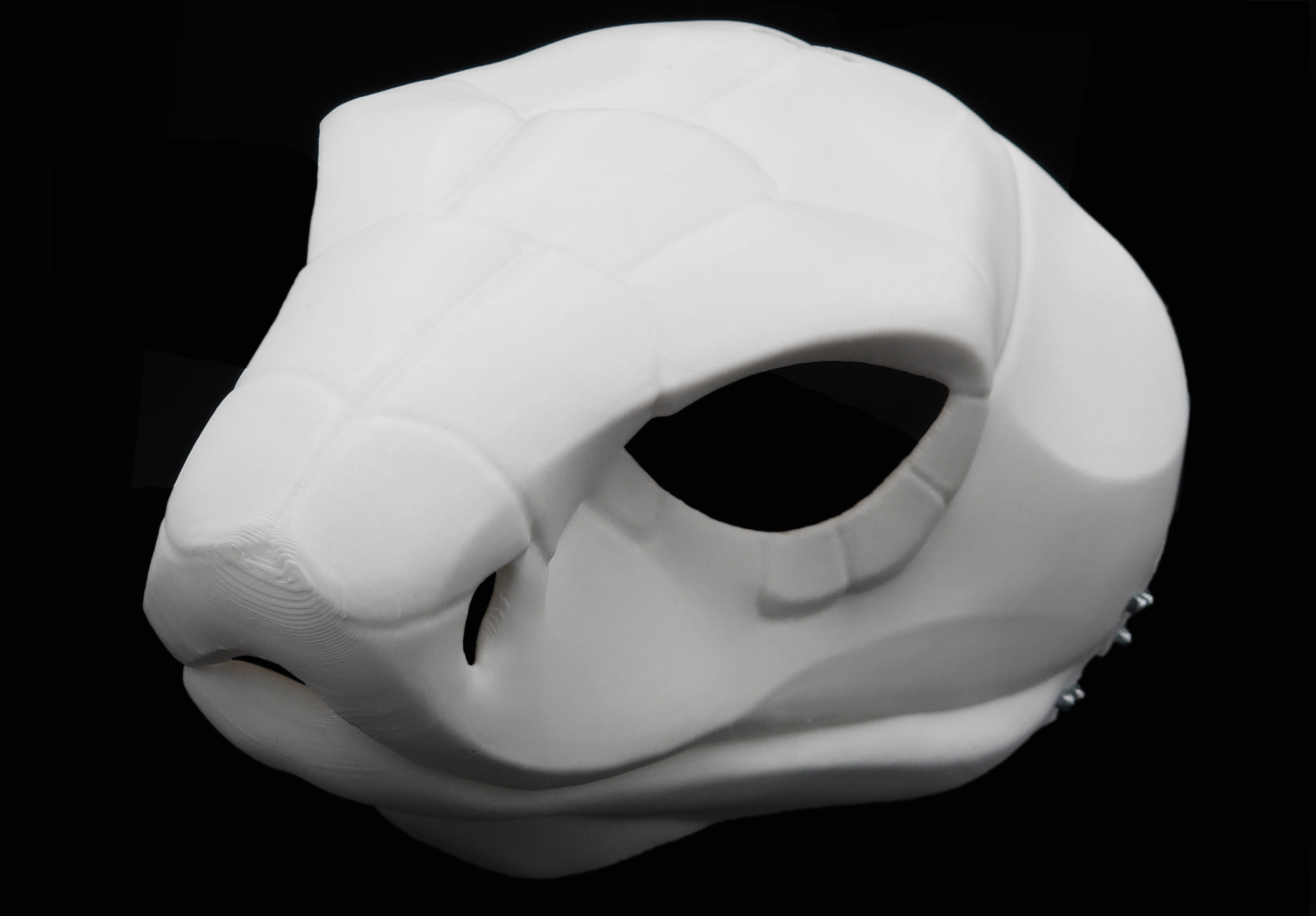 Photo showing a white, plastic 3D printed cobra snake fursuit head base complete with metal hardware at a 3/4 angle against a black background.