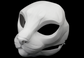 Photo showing a white, plastic 3D printed house cat fursuit head base complete with metal hardware at a 3/4 angle against a black background.