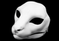 Photo showing a white, plastic 3D printed serval fursuit head base complete with metal hardware at a 3/4 angle against a black background.