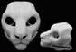 Photo collage showing a white, plastic 3D printed snow leopard fursuit head base complete with metal hardware featuring a front and side view against a black background.