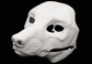 Photo showing a white, plastic 3D printed wolf fursuit head base complete with metal hardware at a 3/4 angle against a black background.