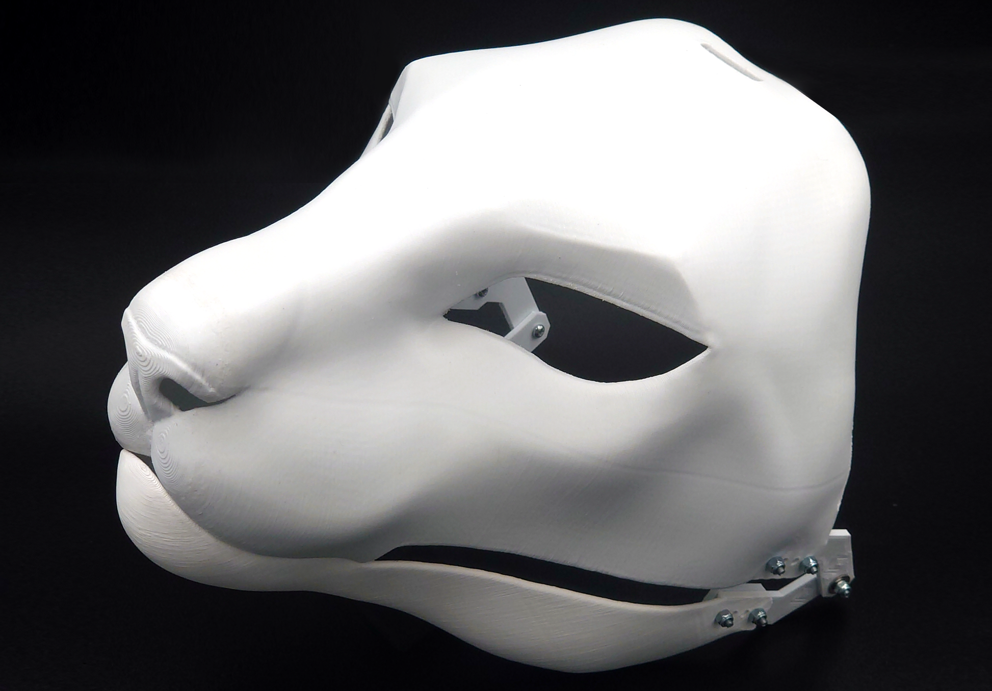 Photo showing a white, plastic 3D printed oriental cat fursuit head base complete with metal hardware at a 3/4 angle against a black background.