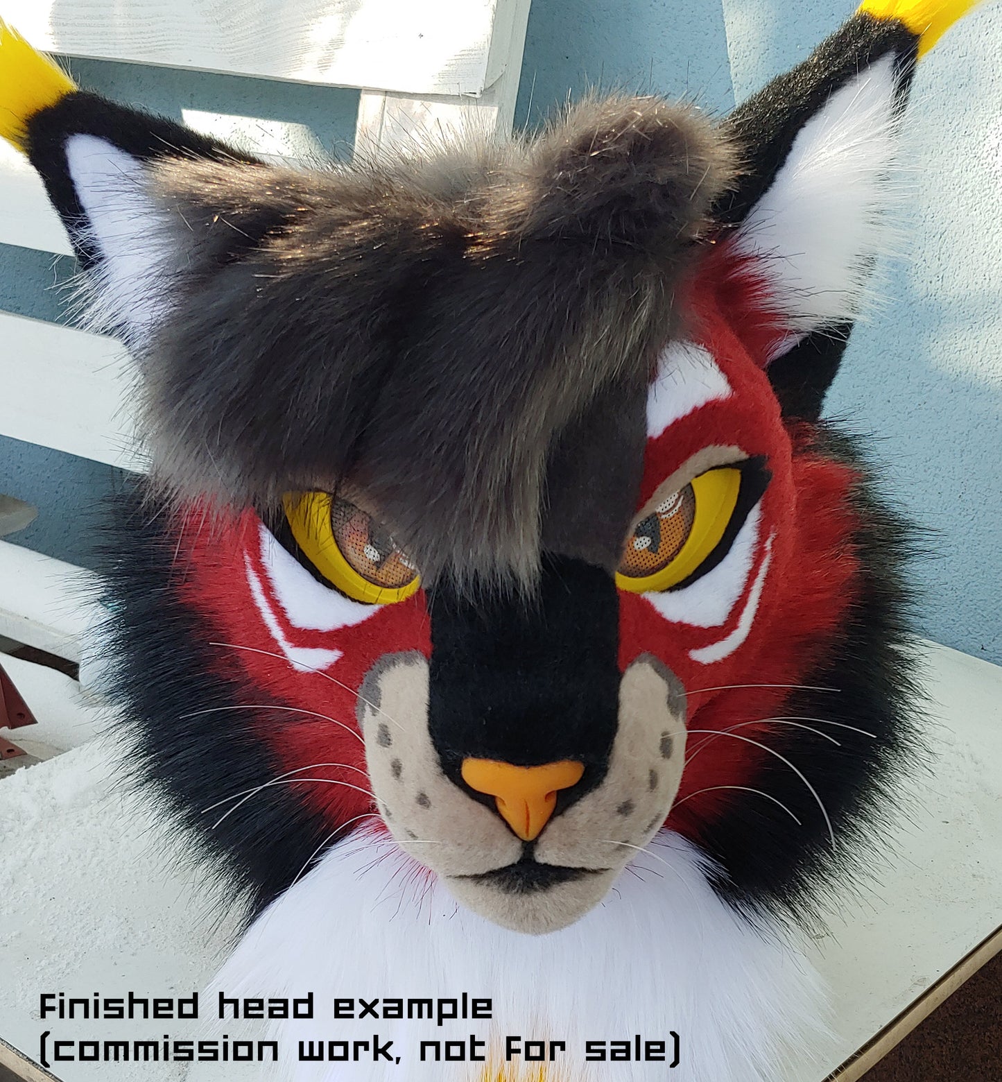 Photo showing an example finished mask/fursuit head built on the small feline base sold through the associated listing.